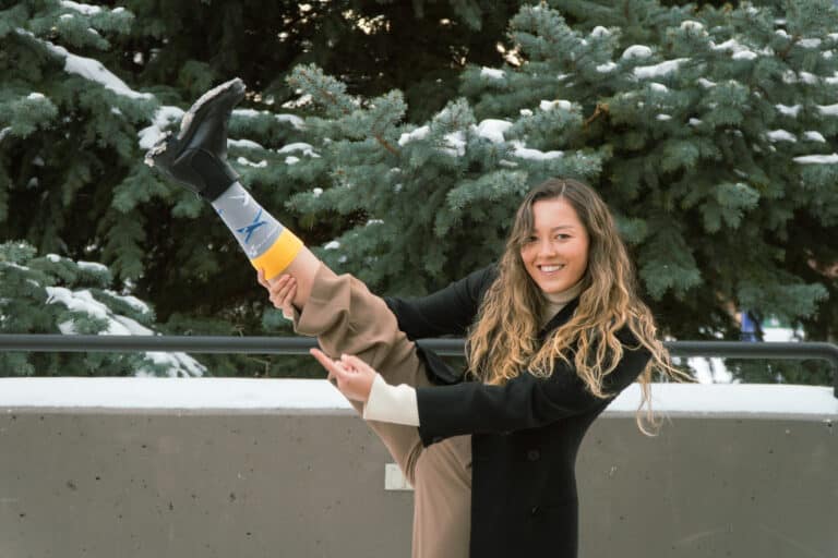 Julia Bicknell, SKYTRAC Systems Engineer, flaunts her SKYTRAC socks