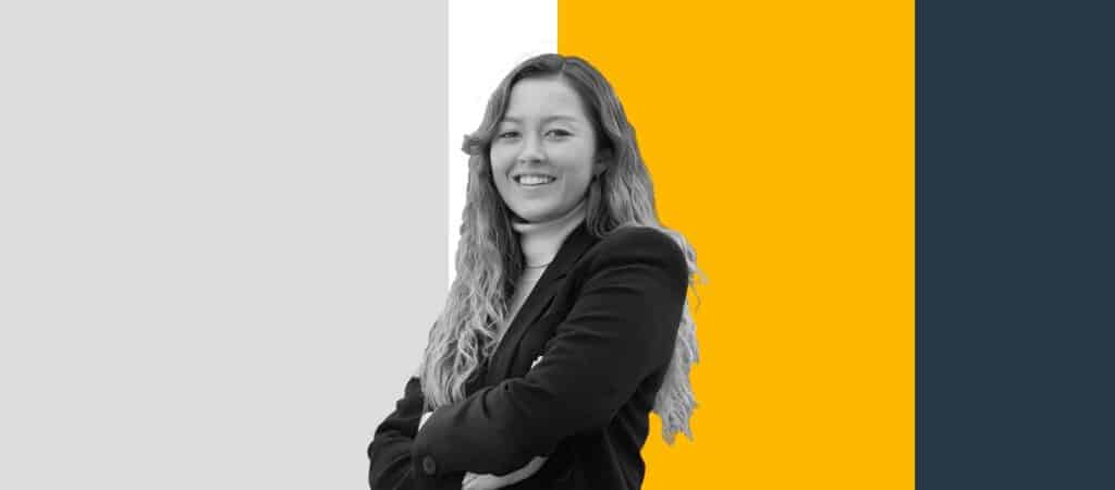 Julia Bicknell, SKYTRAC Systems Engineer, stands cross armed