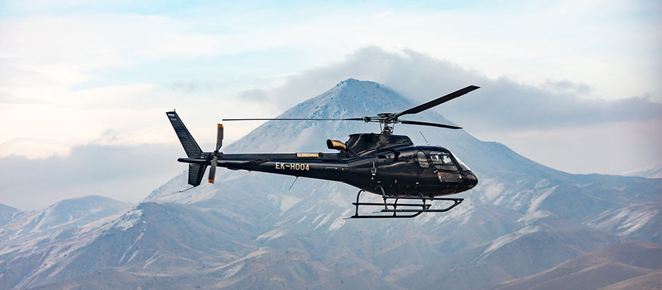 Helicopter in flight in the mountains