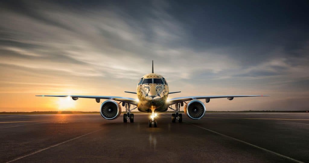 Embraer E175 on the runway at sunset