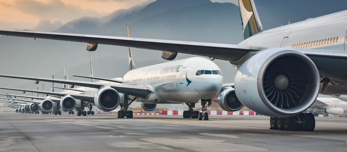 Fixed wing aircraft on runway with mountains in the background