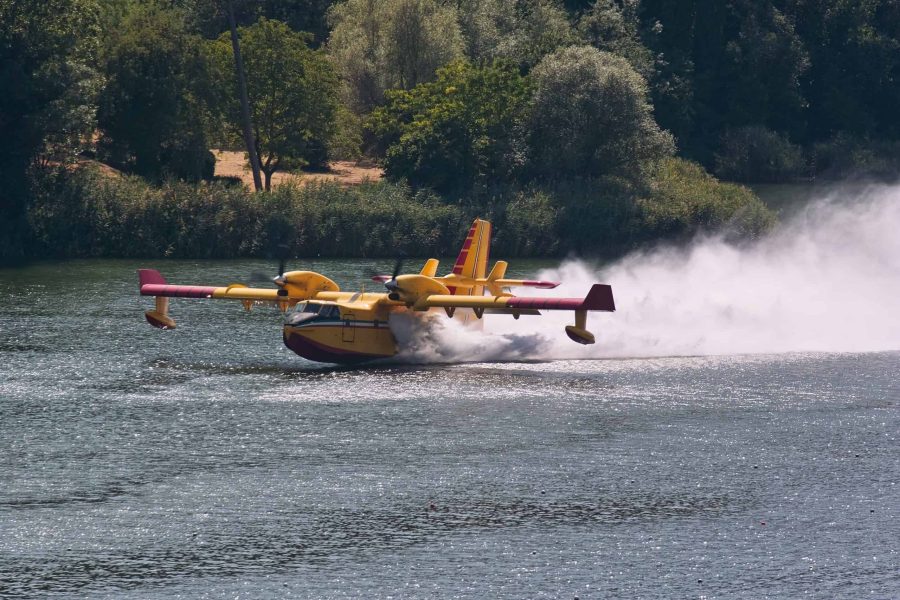 amphibious aerial firefighting aircraft collects water on a lake