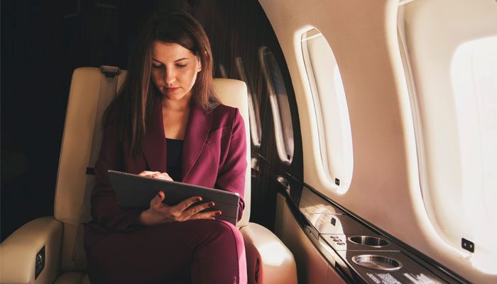 Business-Women-in-Private-Jet-Using-a-Tablet-That-is-Connected-to-Broadband-Internet-Using-SKYTRAC-Satcom-Services Business Women in Private Jet Using a Tablet That is Connected to Broadband Internet Using SKYTRAC Satcom Services
