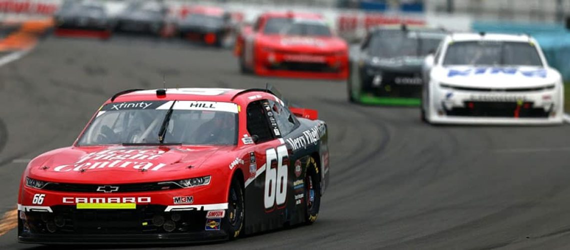 Red Chevrolet Camaro painted with Mercy Flight colours on NASCAR race track