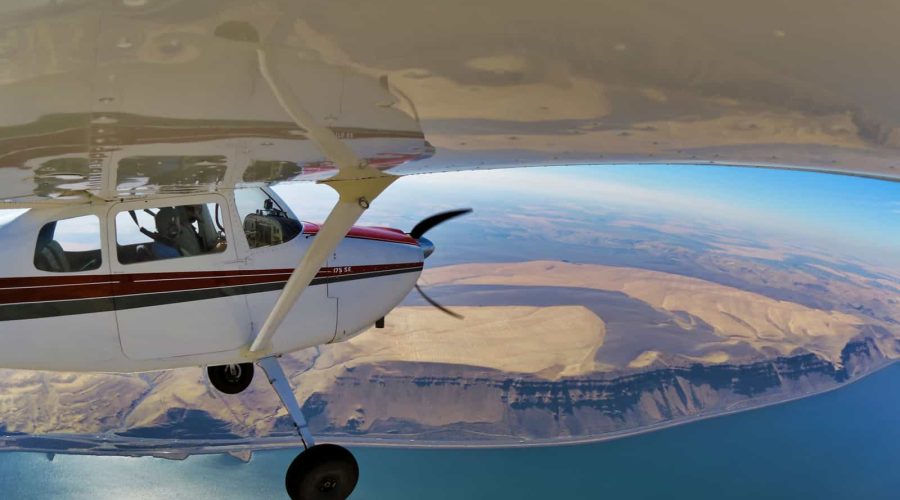 general-aviation-cessna-175-in-flight-over-river general-aviation-cessna-175-in-flight-over-river
