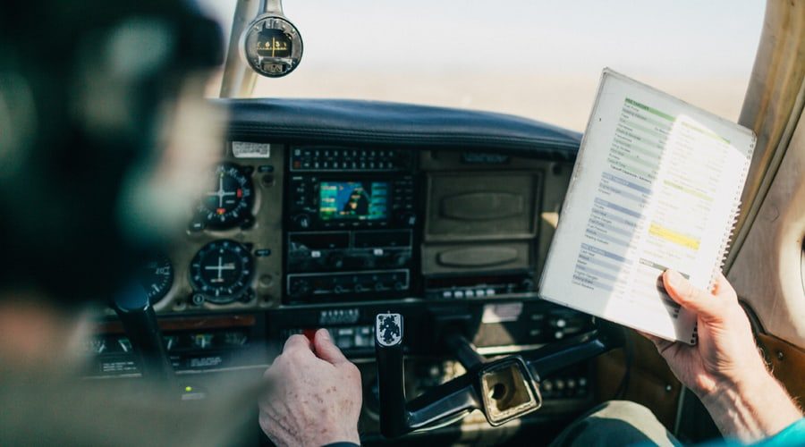 general-aviation-flight-school-instructor-teaching-student-with-preflight-checklist