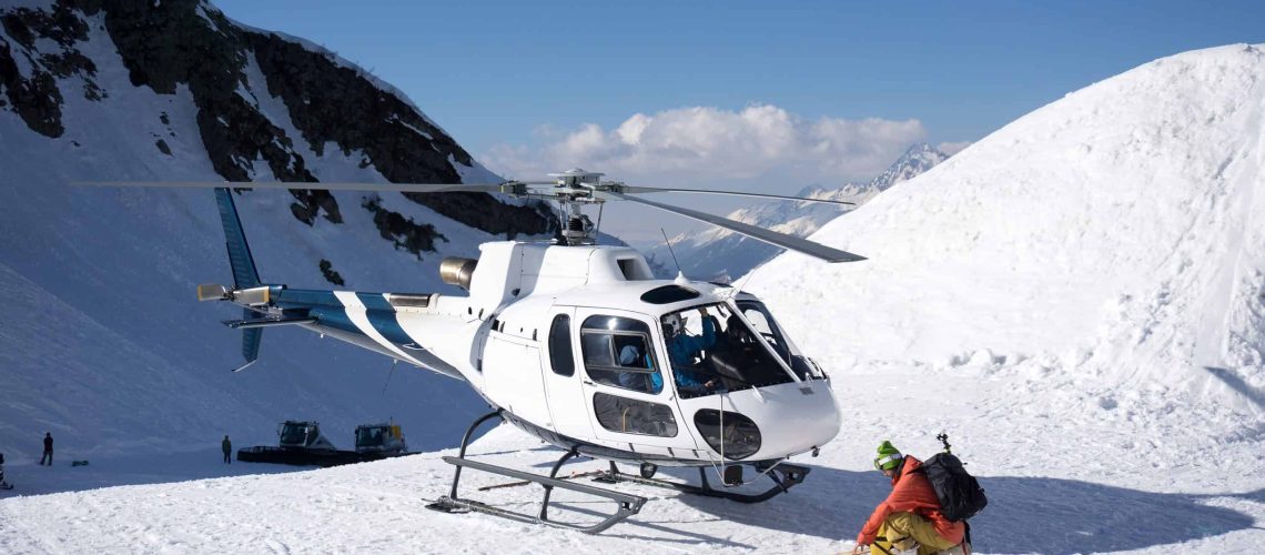White,Rescue,Helicopter,Parked,In,The,Snowy,Mountains